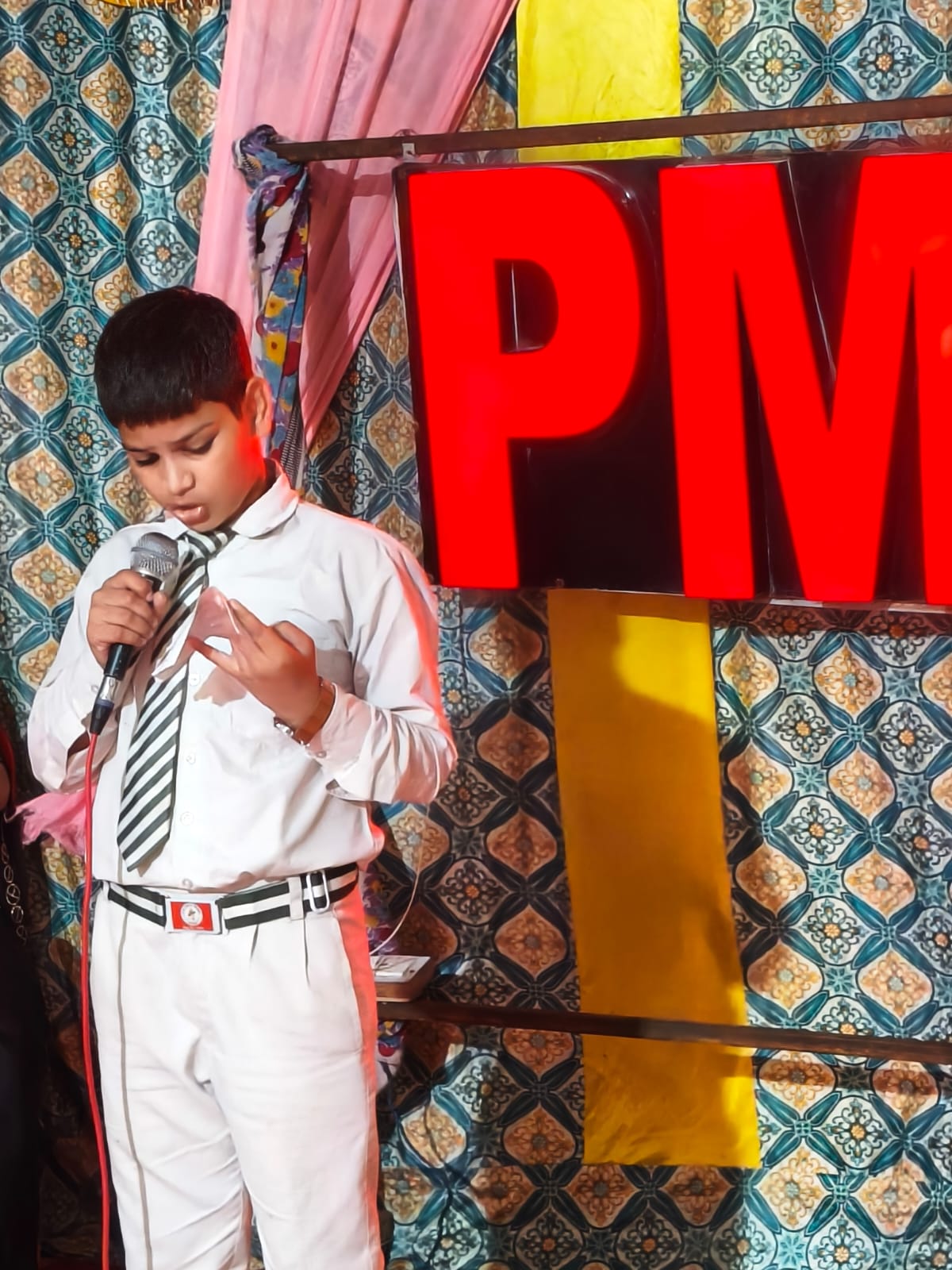 Student giving a speech on stage at PM Public School Jattari